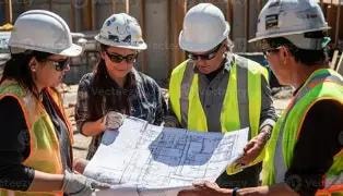 Building inspector on construction site with tablet